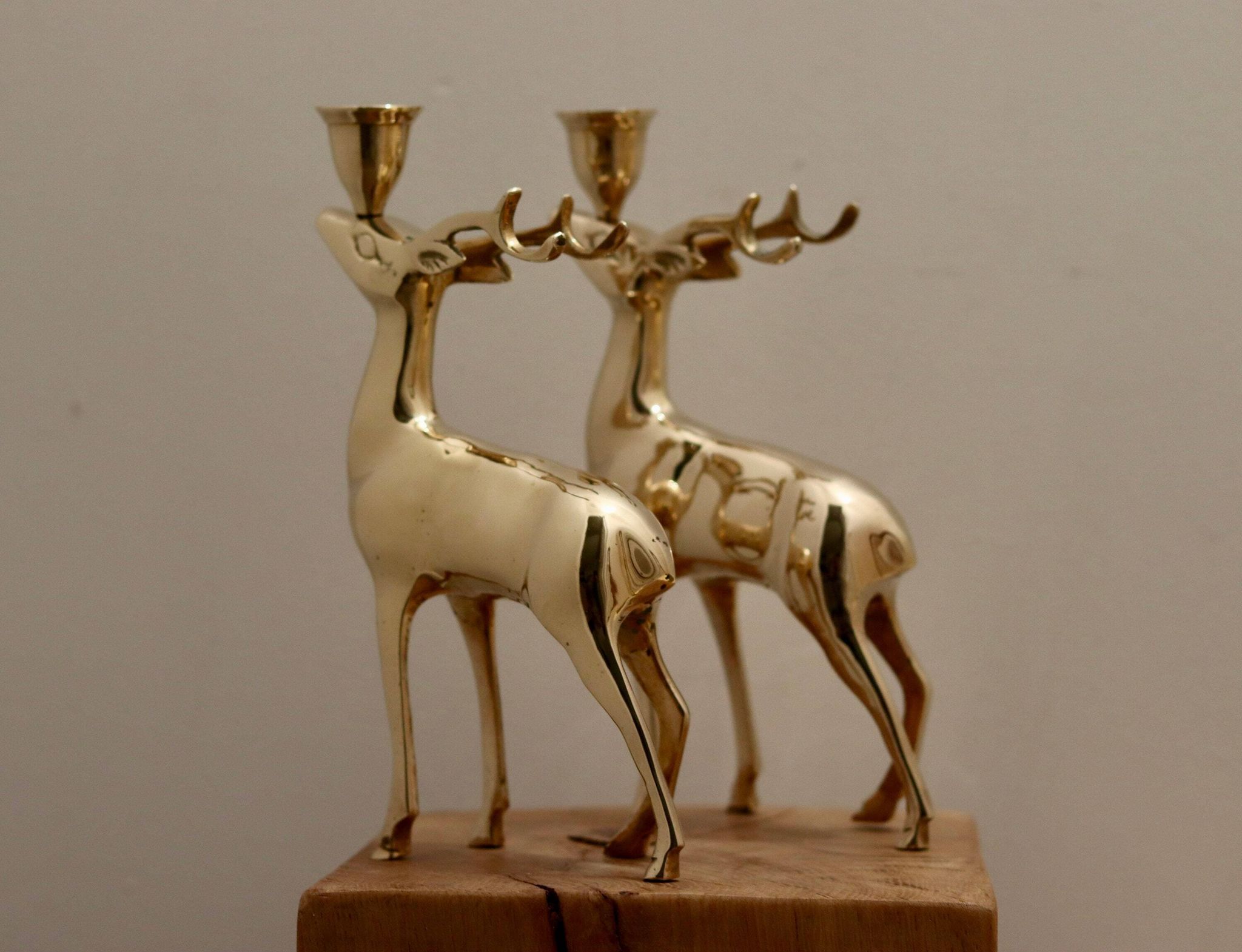 Pair of brass candle holders in the shape of deer from the mid-century.