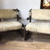 Set of 2 vintage wooden chairs with beige sheepskin seats, rustic style.