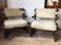 Set of 2 vintage wooden chairs with beige sheepskin seats, rustic style.