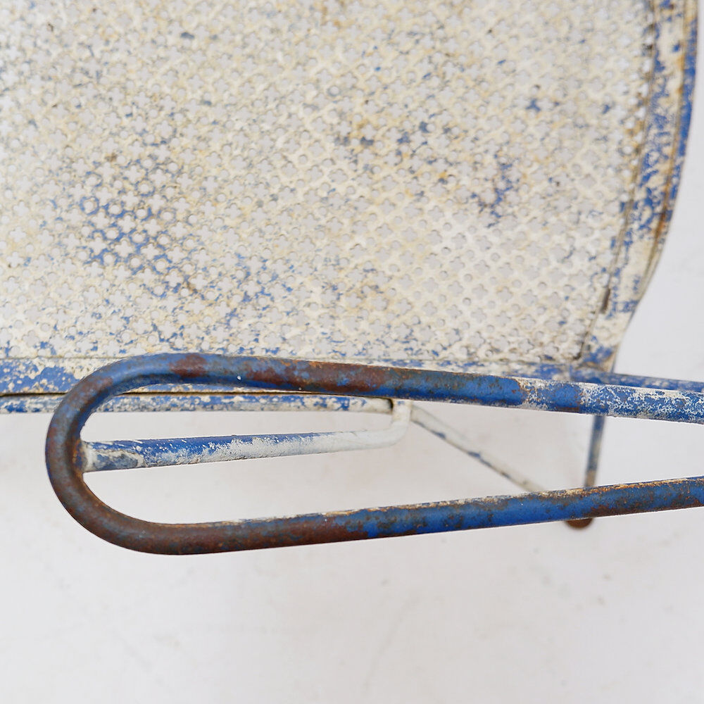 Vintage perforated metal armchair from the 1950s.