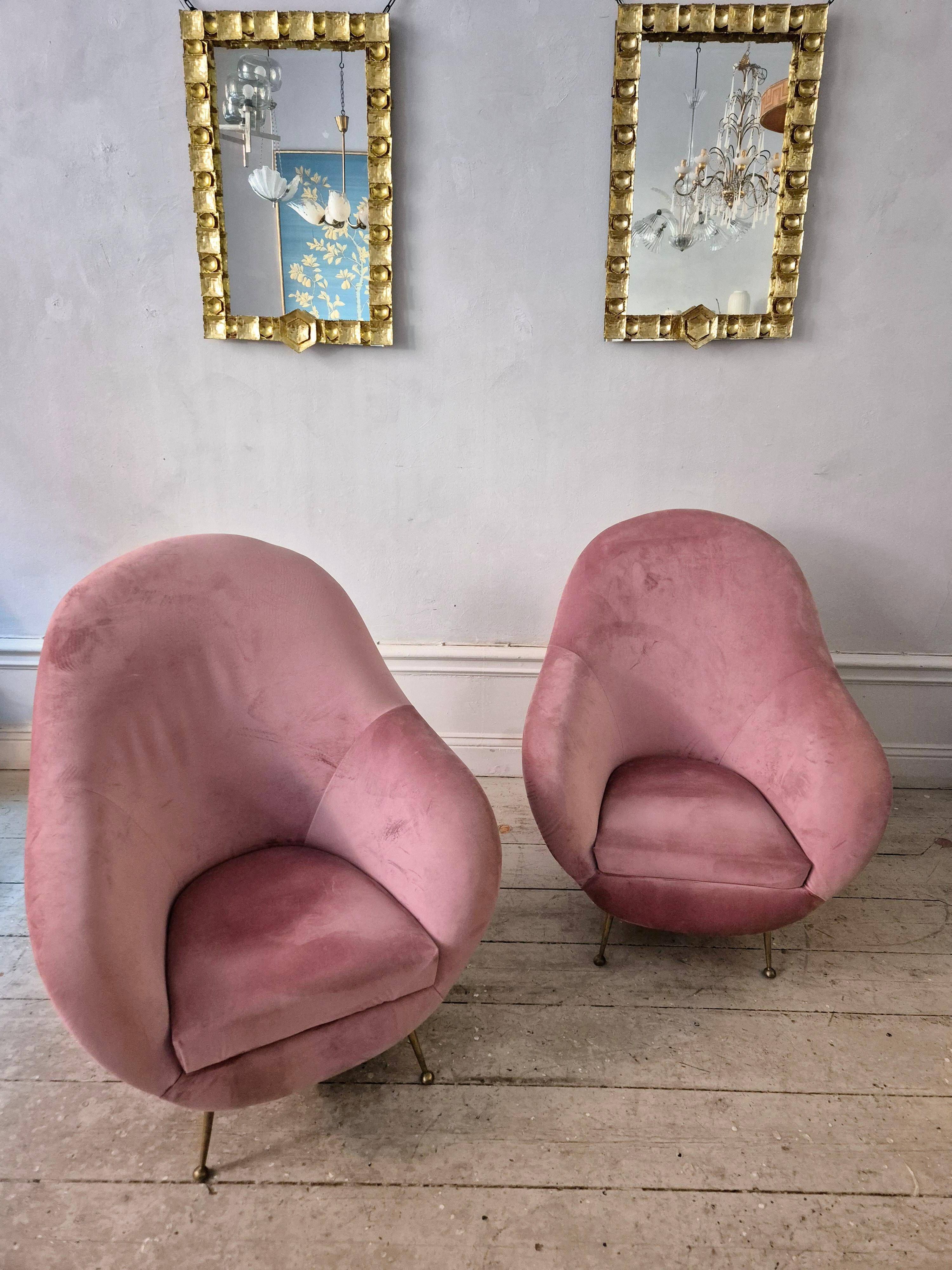 An elegant pair of armchairs with brass legs, Italy from the mid-20th century.