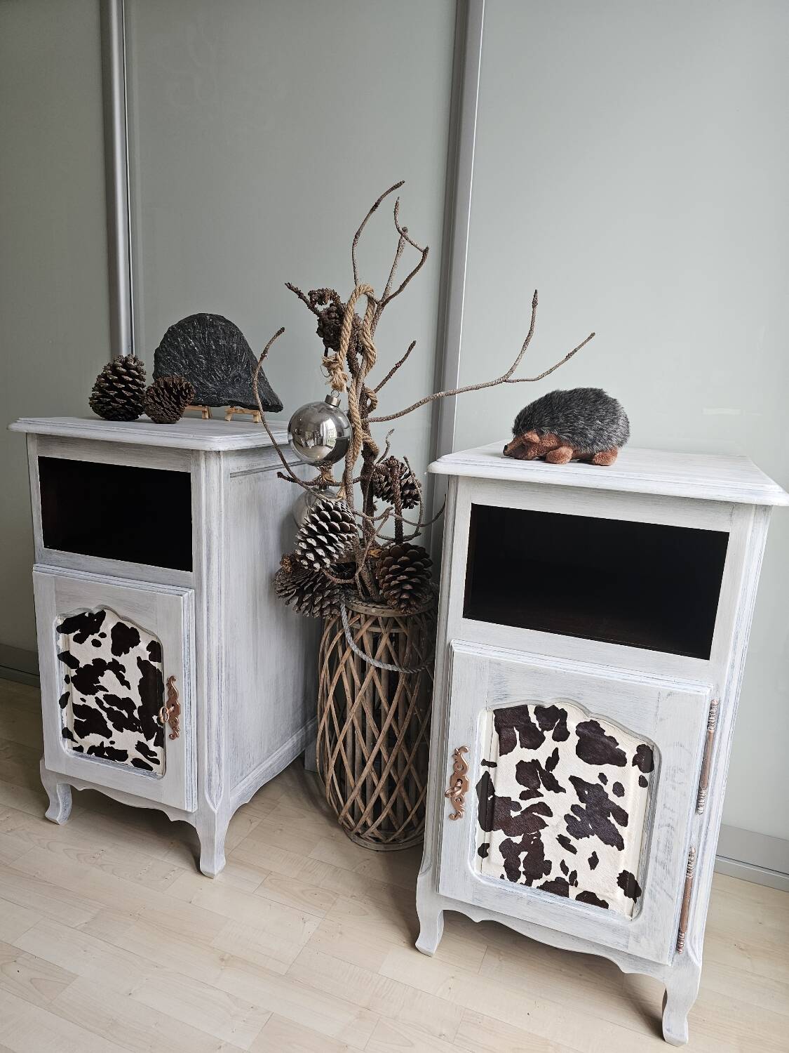 Two solid wood bedside tables with calfskin decoration.