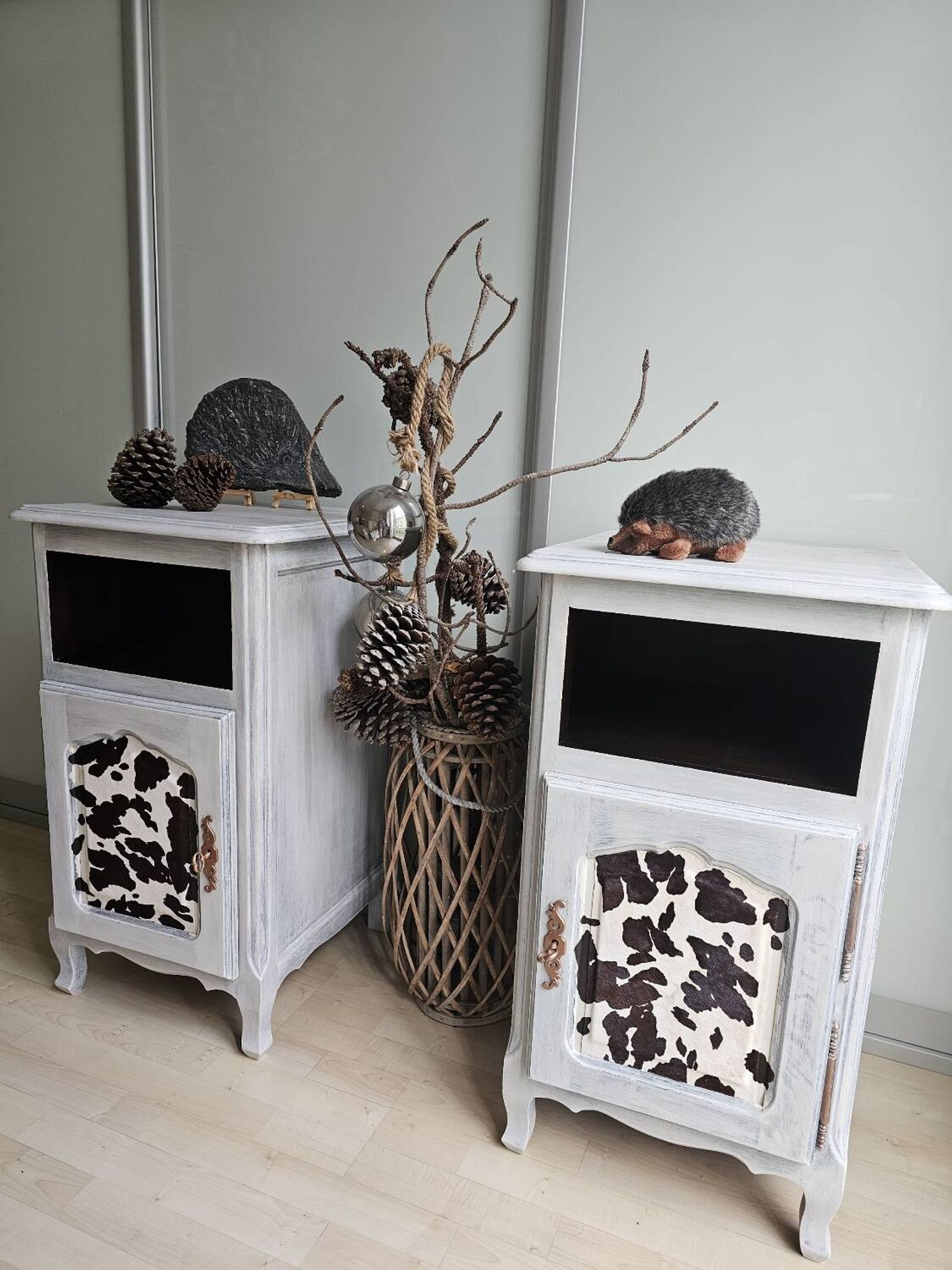Two solid wood bedside tables with calfskin decoration.