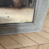 Old mirror with light green contours with mauve shades