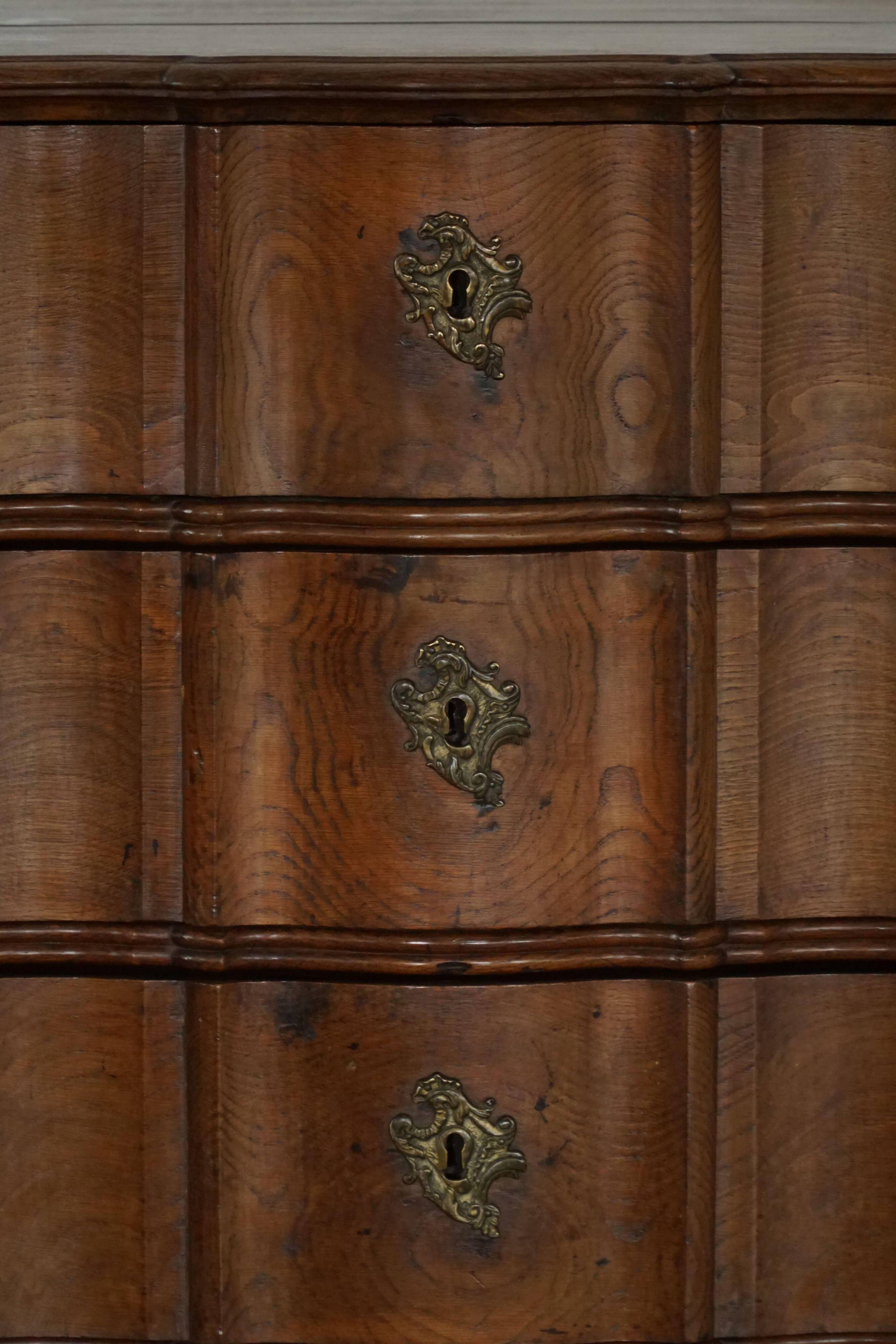 Antique baroque oak commode from the late 18th century with cabriole legs.