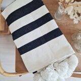 Hand-woven plaid with black stripes and white pompoms