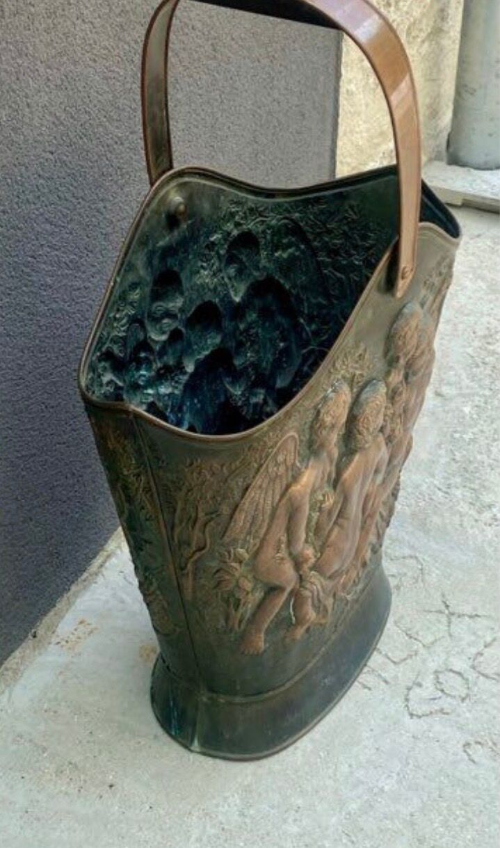 Antique red copper umbrella stand decorated with putti angels.