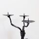 Large wrought iron candelabrum with an abstract design and three candle holders.