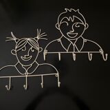 Pair of iron coat holders girl and boy
