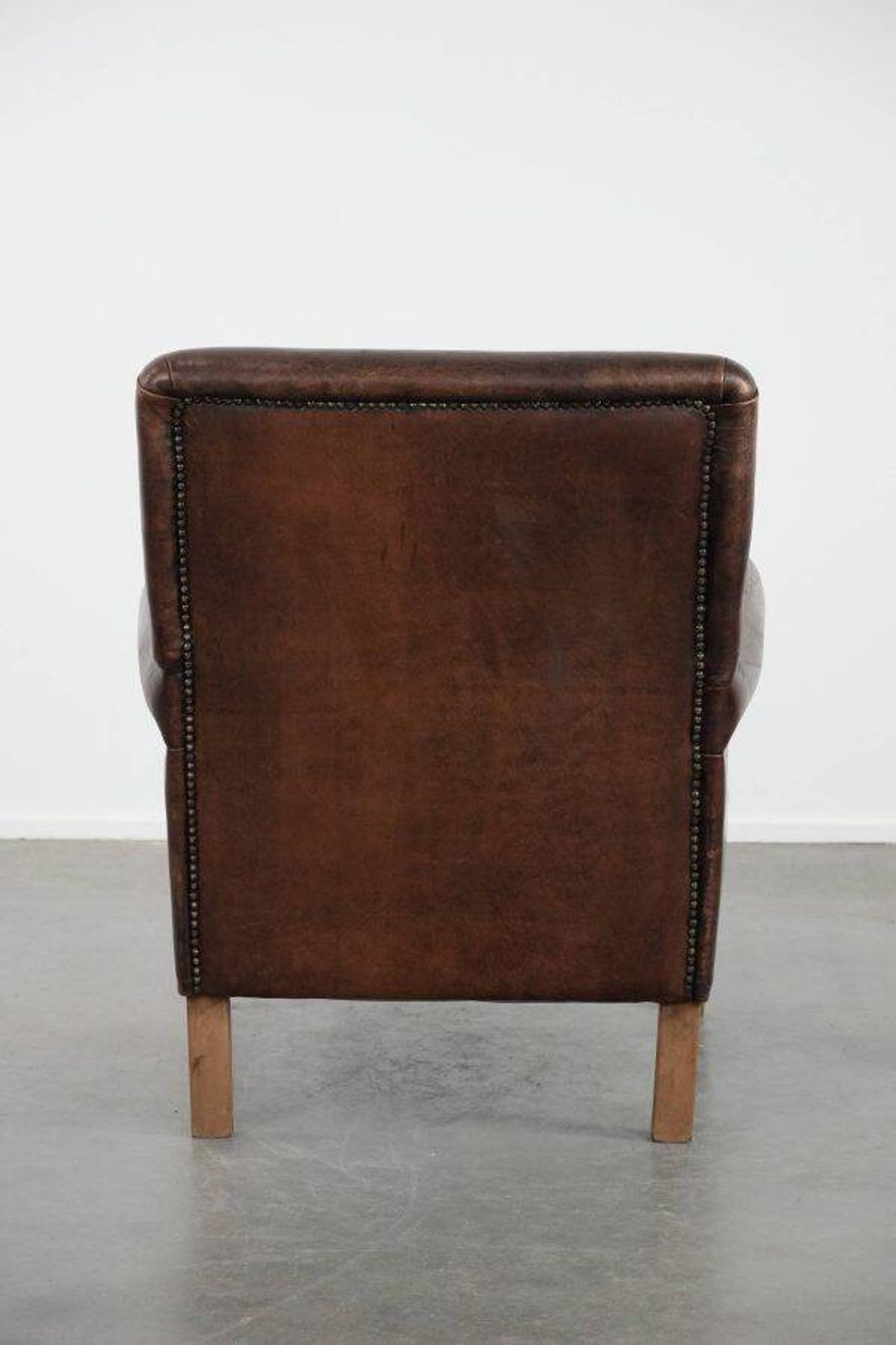 Characterful sheep leather armchair with a beautiful deep colour