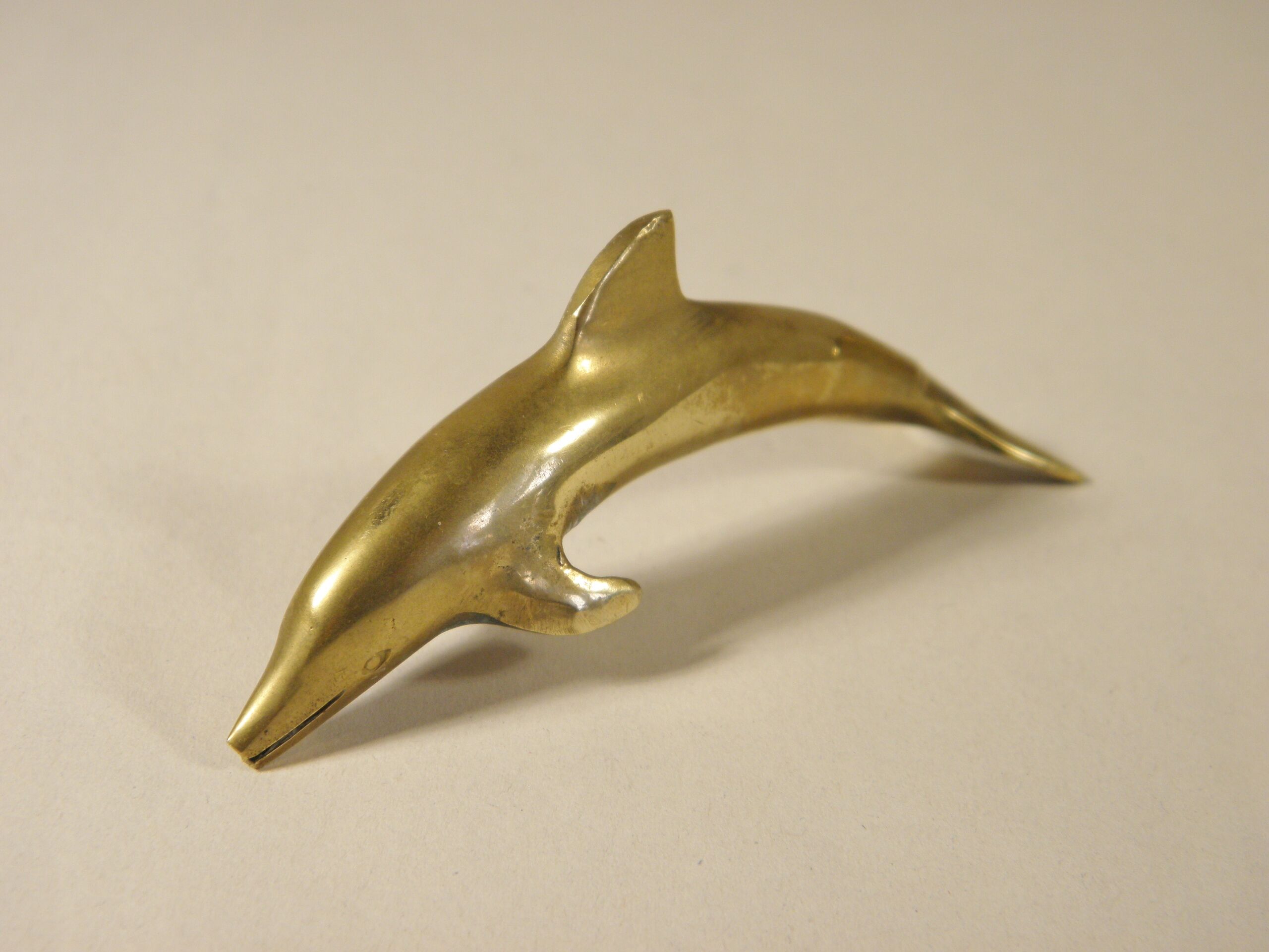Three brass dolphins