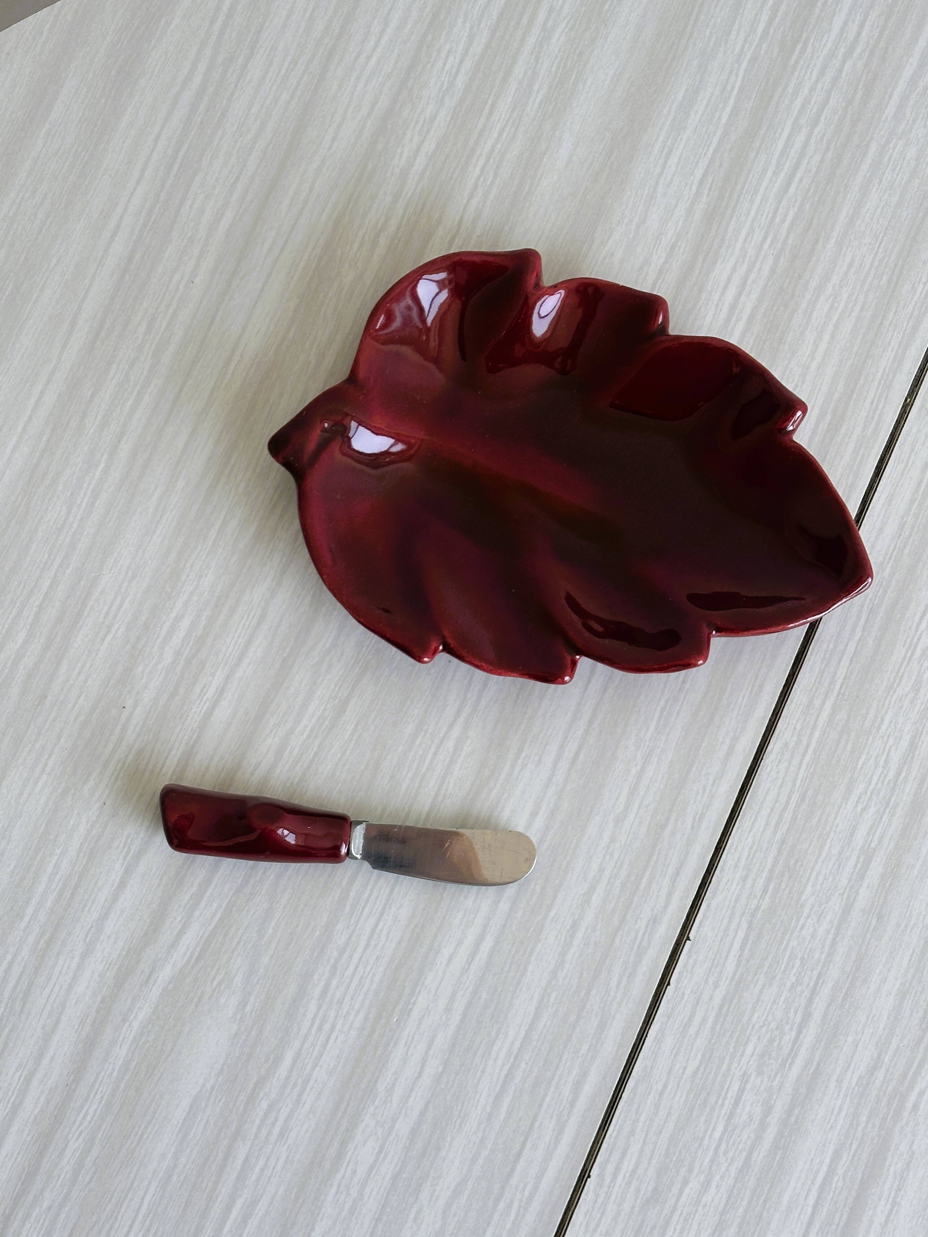 Red ceramic butter dish with knife