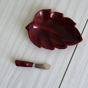 Red ceramic butter dish with knife