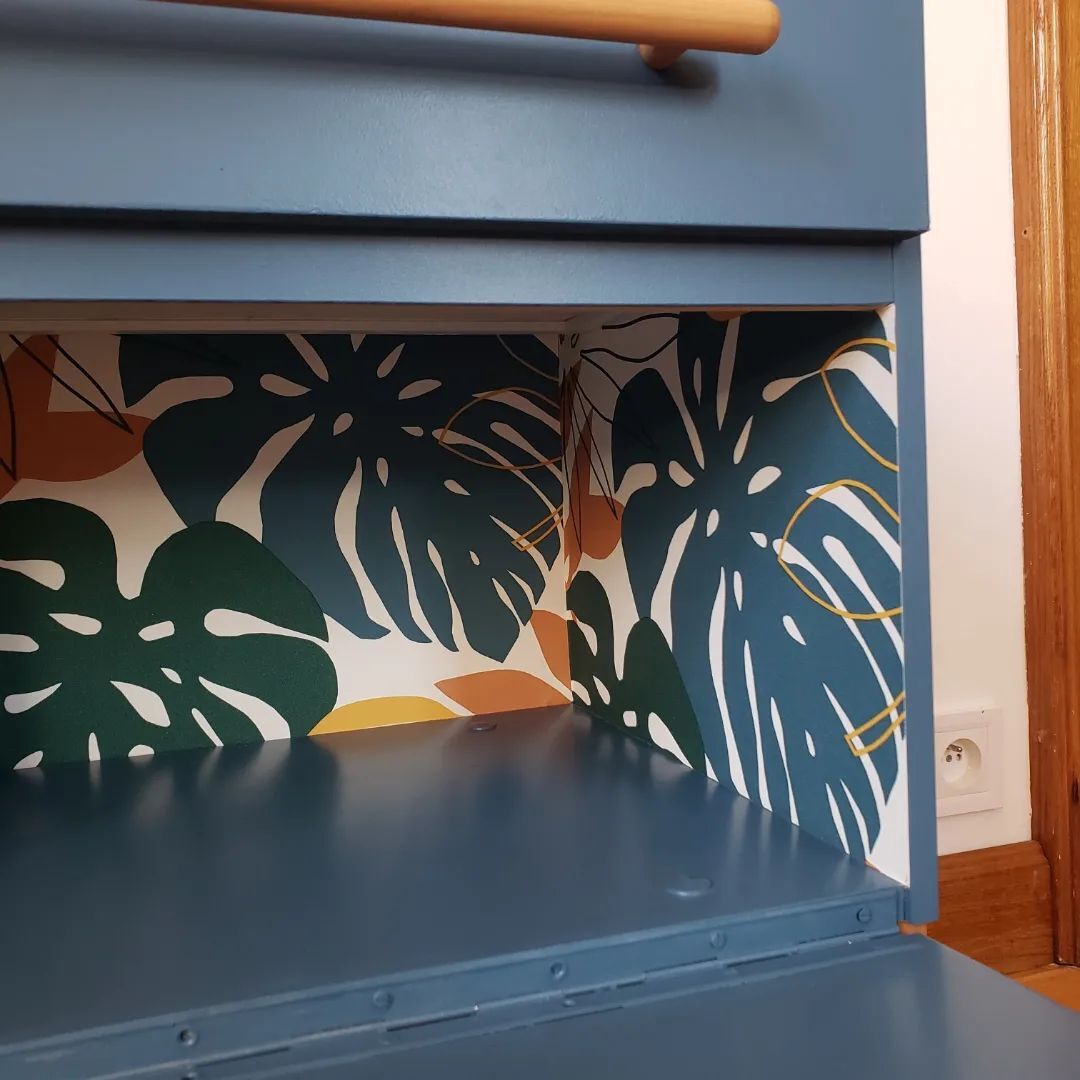 Blue sixties cabinet and monstera leaves