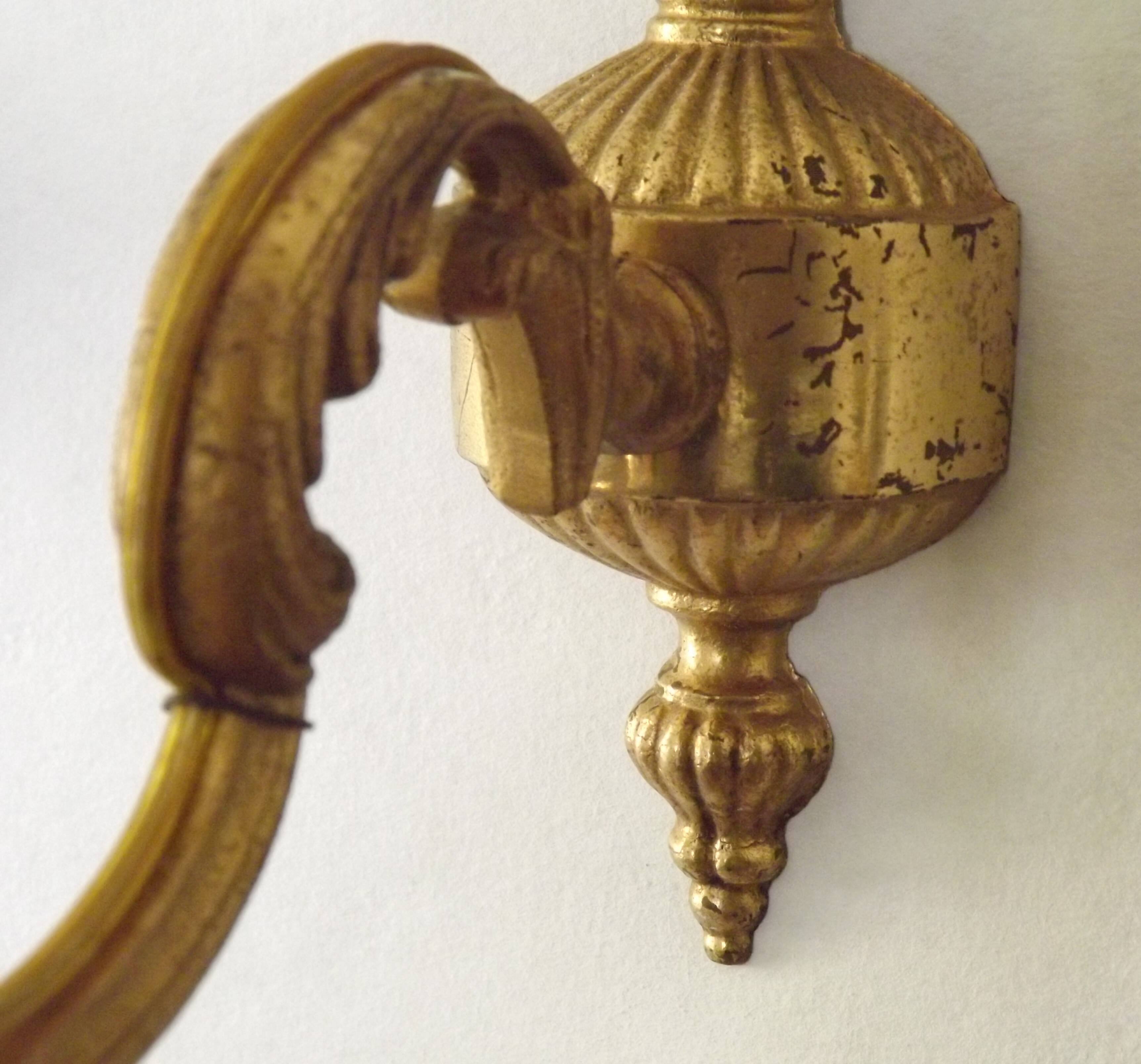 Pair of simple vintage French wall sconces in Art Nouveau bronze with leaf-shaped details.