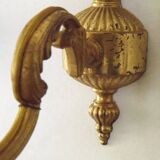 Pair of simple vintage French wall sconces in Art Nouveau bronze with leaf-shaped details.