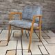 Vintage armchair from the 60s/70s in wood and grey fabric – with armrests.