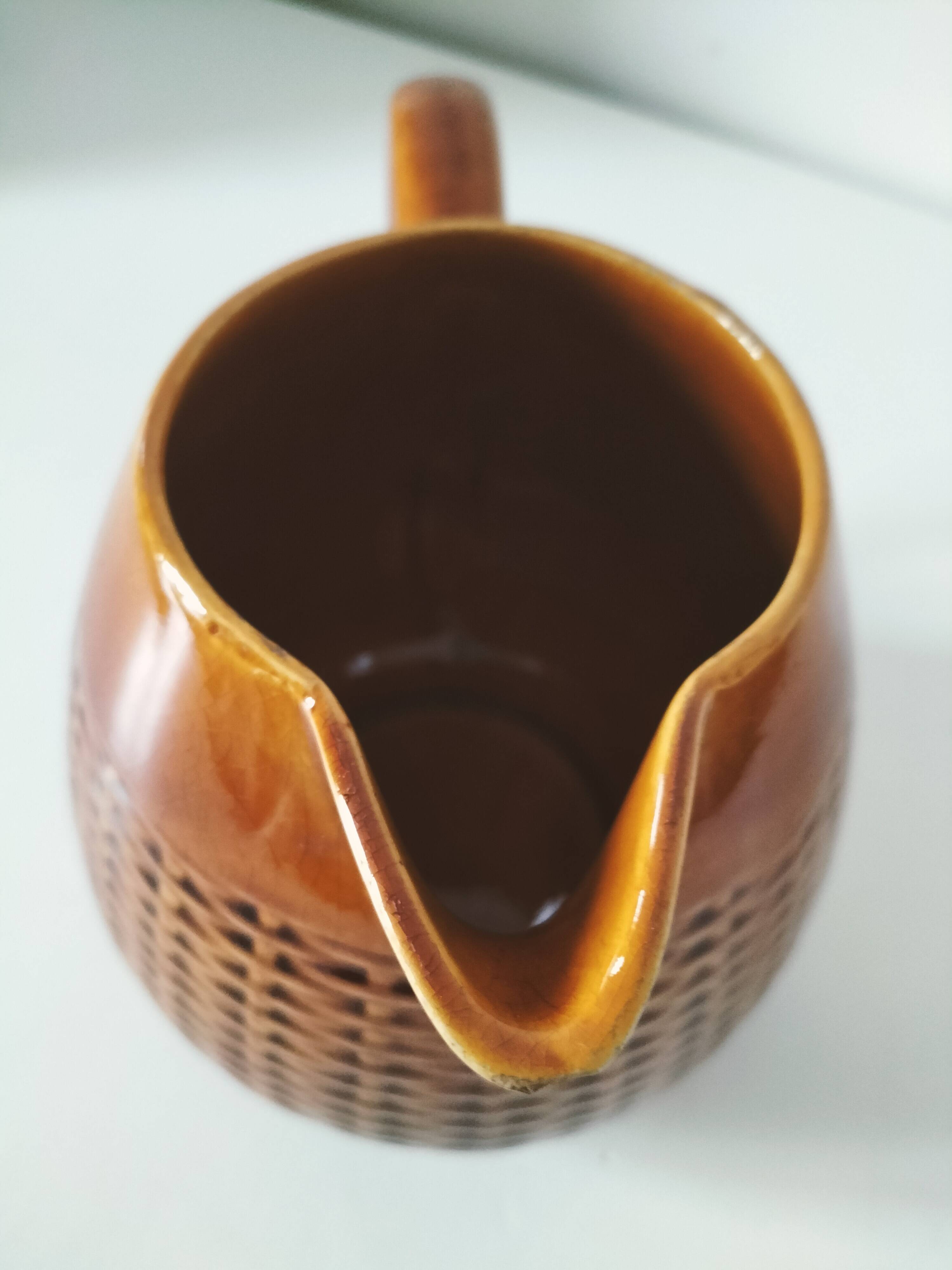 Caramel slipware pitcher with braided relief
