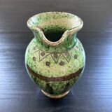 Old pitcher with ethnic decor
