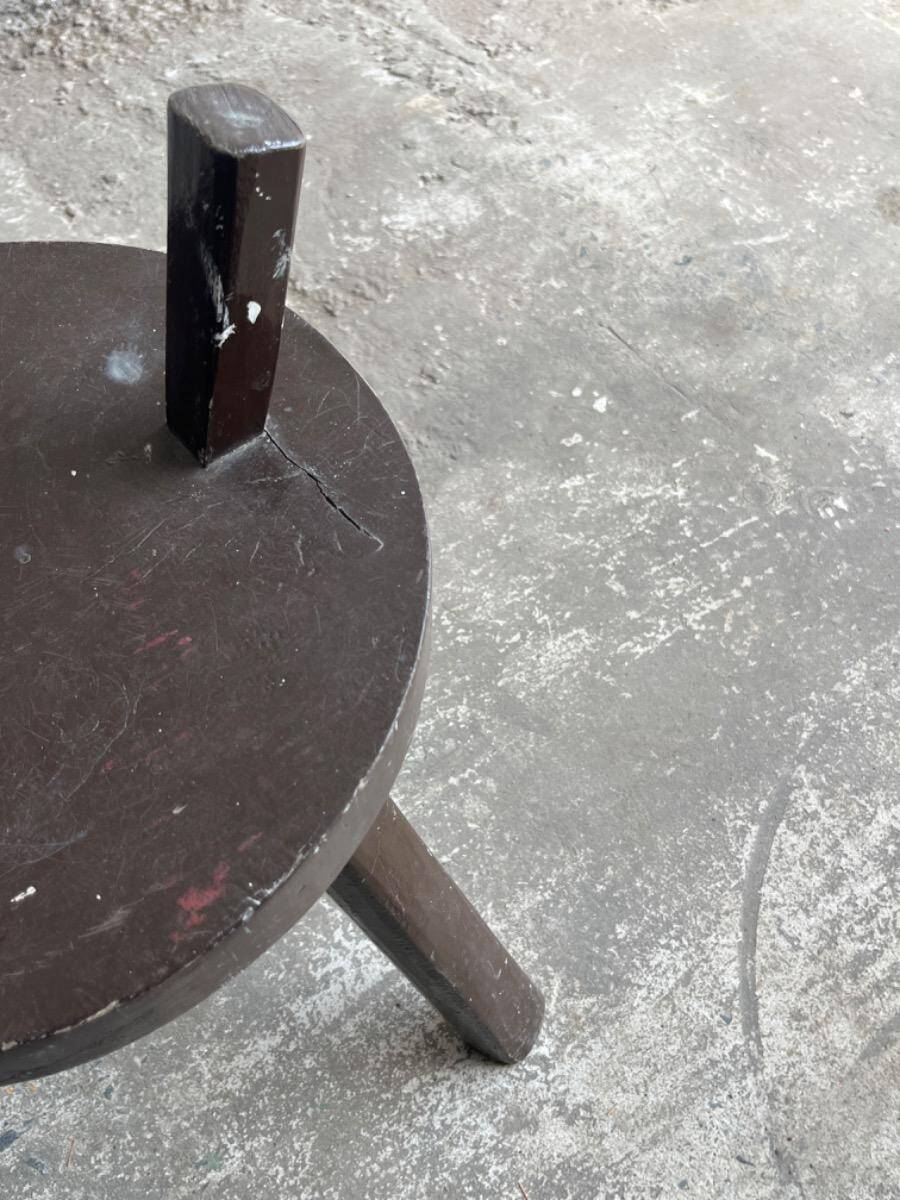 Black solid wood vintage tripod stool with angled back peg — France, 1960s