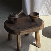Small stool, oval solid teak side table with curved legs in wabi-sabi style.