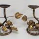 Pair of brass candle holders decorated with patinated metal flowers