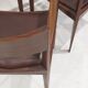 Set of six Italian wooden dining chairs in dark brown faux leather.