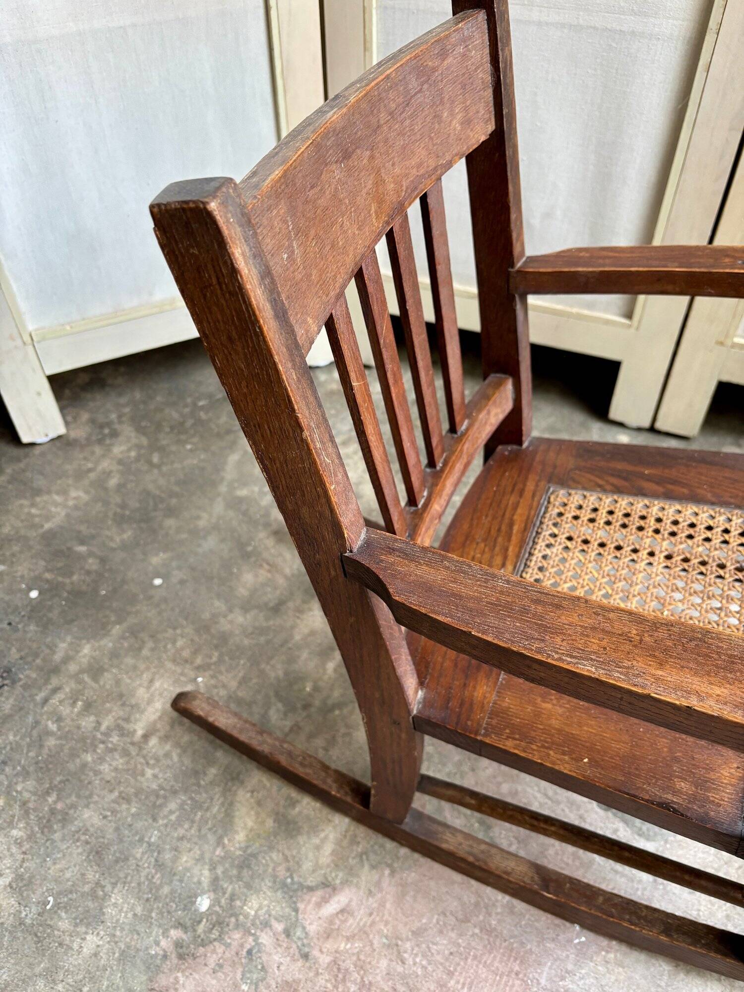 Children's rocking chair in dark wood and cane