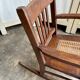 Children's rocking chair in dark wood and cane