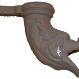 Cast iron gutter downspout in the shape of a dolphin