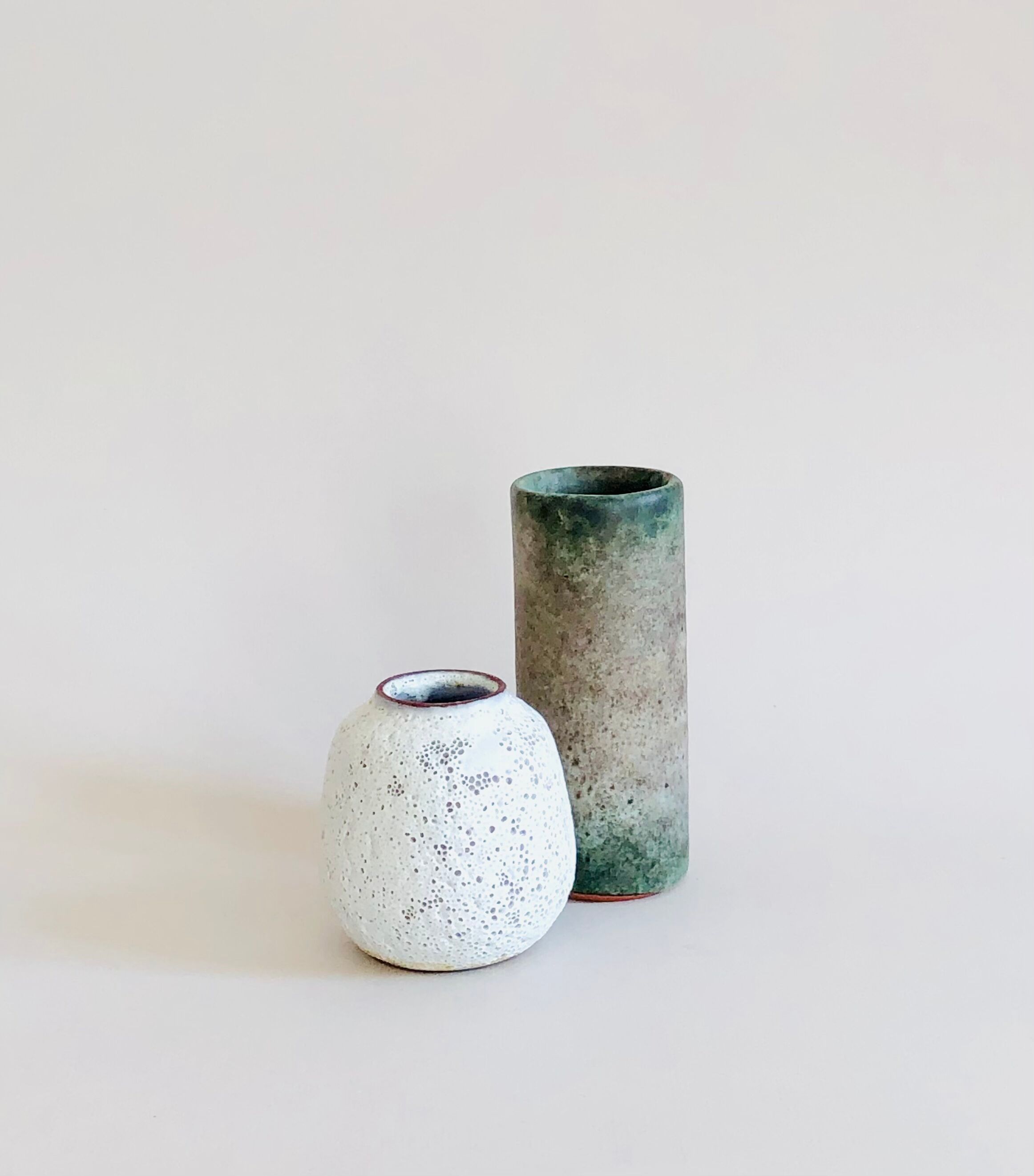 Duo of small sandstone vases
