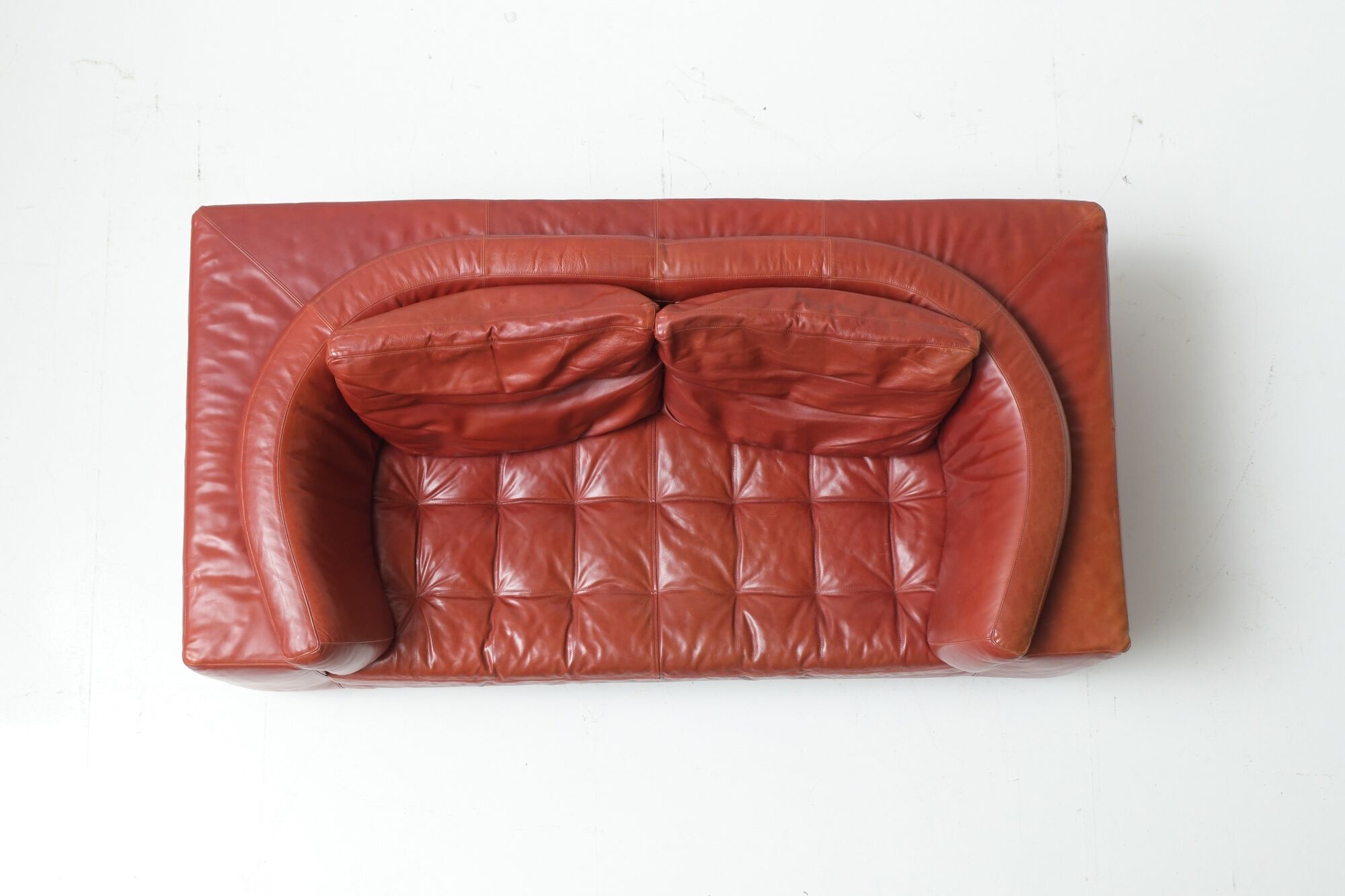 Vintage Osaka loveseat in oxblood leather by Natuzzi Italy