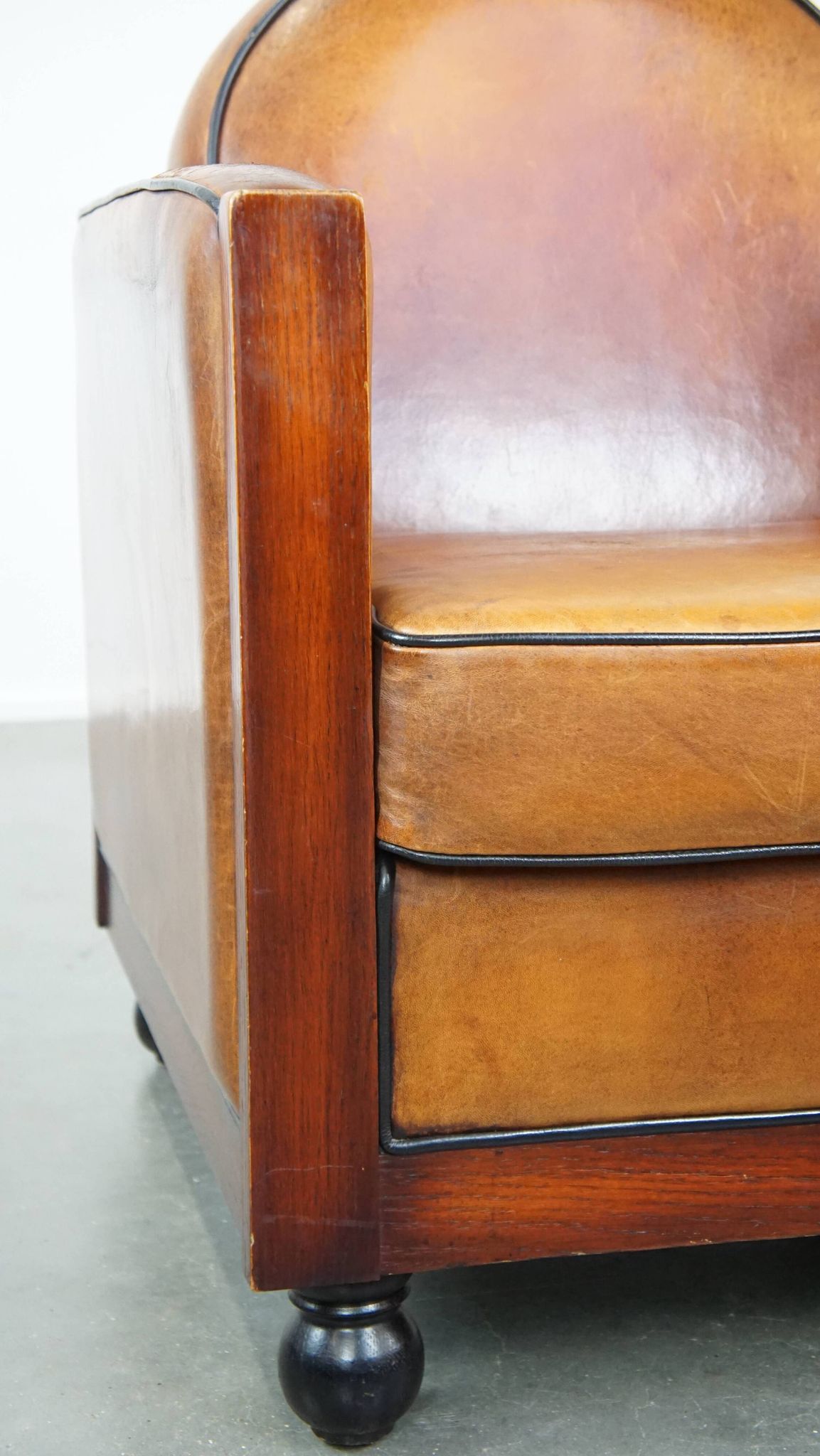 Sheep leather and wooden Art Deco design armchair with ball feet