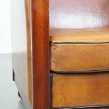 Sheep leather and wooden Art Deco design armchair with ball feet