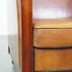 Sheep leather and wooden Art Deco design armchair with ball feet