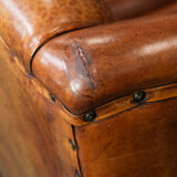 Wingback chair made of sheep leather with black piping in good condition