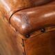 Wingback chair made of sheep leather with black piping in good condition