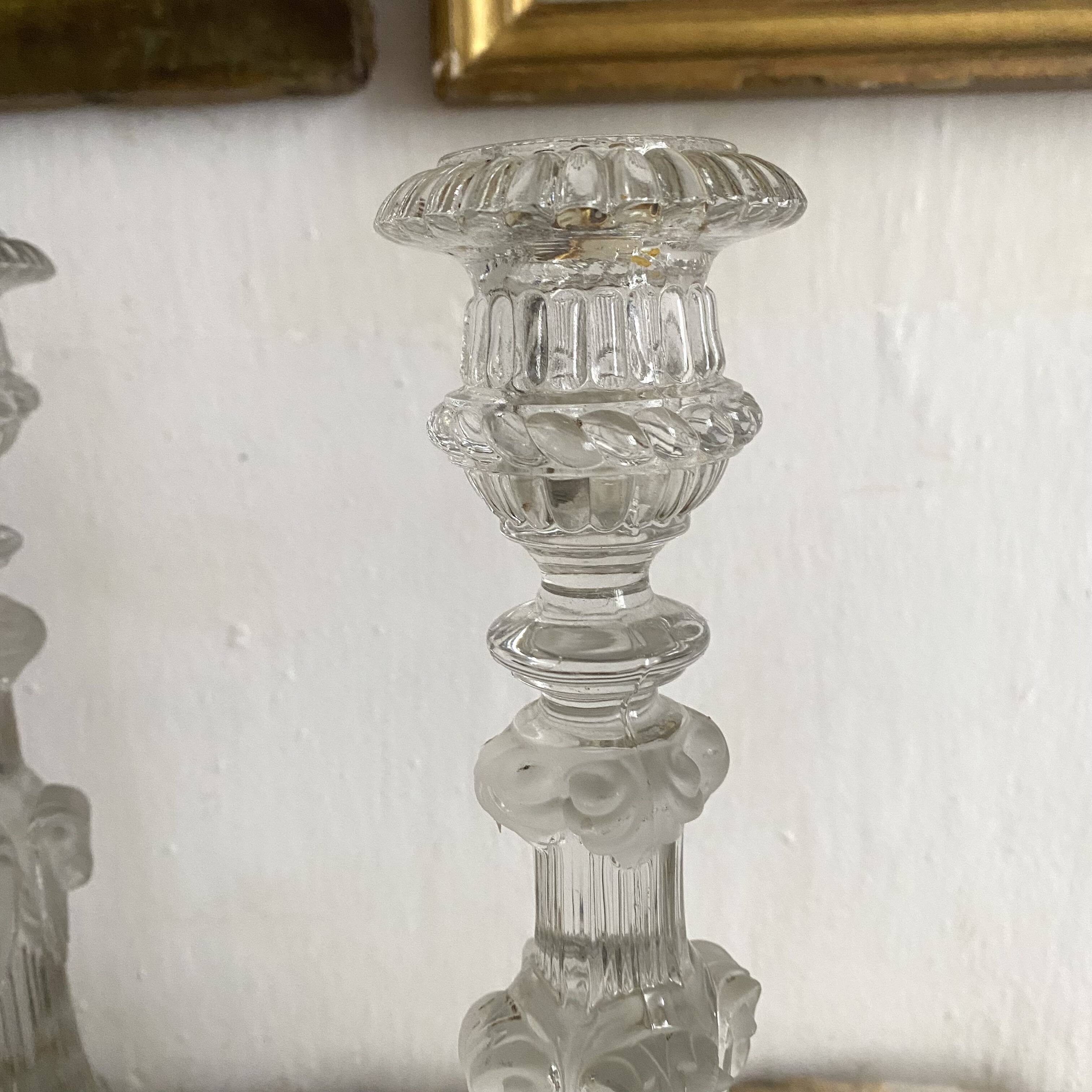 Pair of moulded glass candlesticks, ram heads and masks