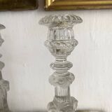 Pair of moulded glass candlesticks, ram heads and masks