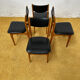 4 Scandinavian chairs in teak and black faux leather.