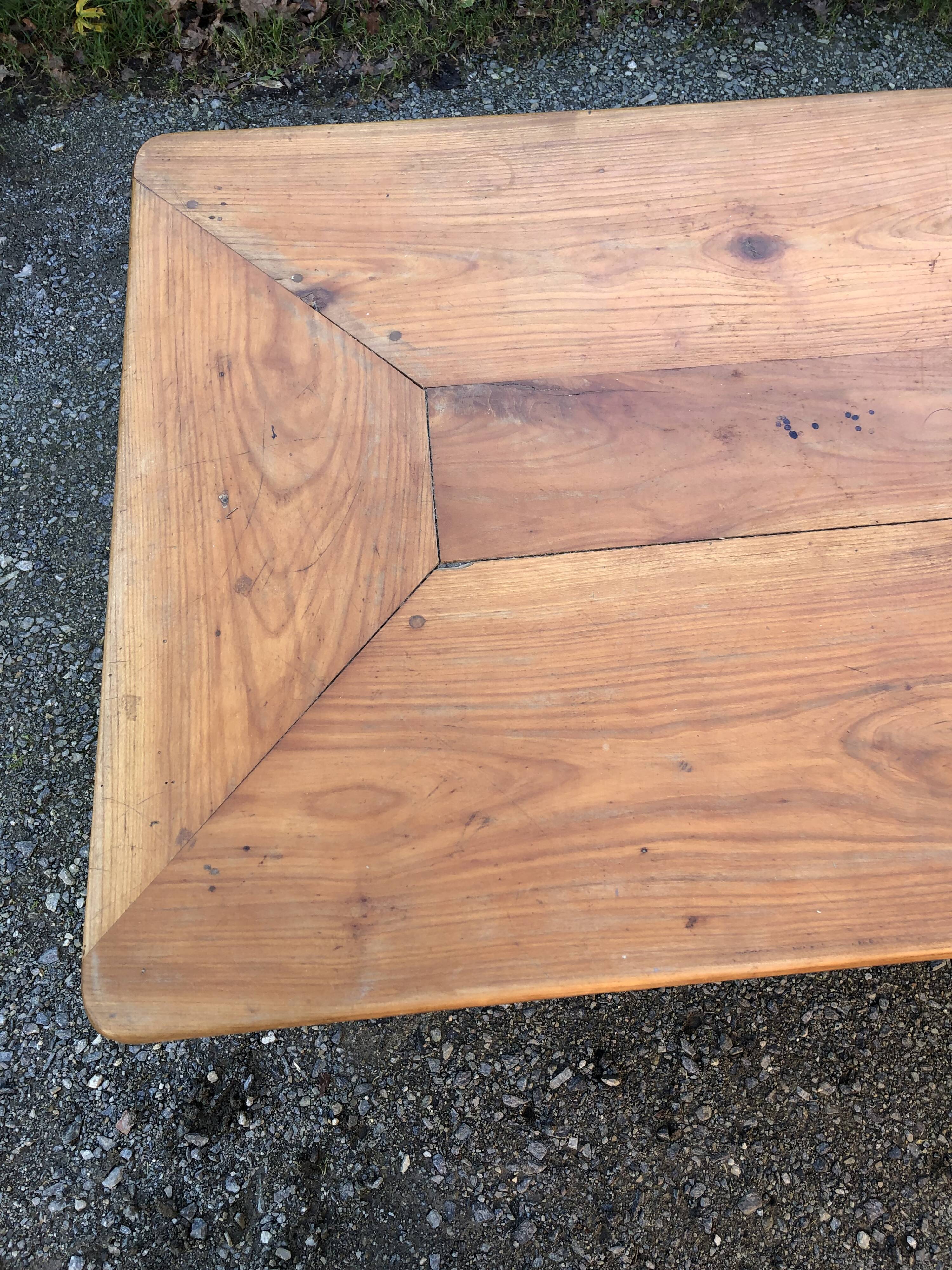 Antique cherry farmhouse table with turned legs and 2 drawers.