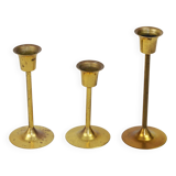 A set of three golden candlesticks, 1970s