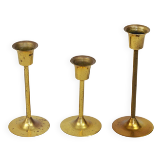 A set of three golden candlesticks, 1970s