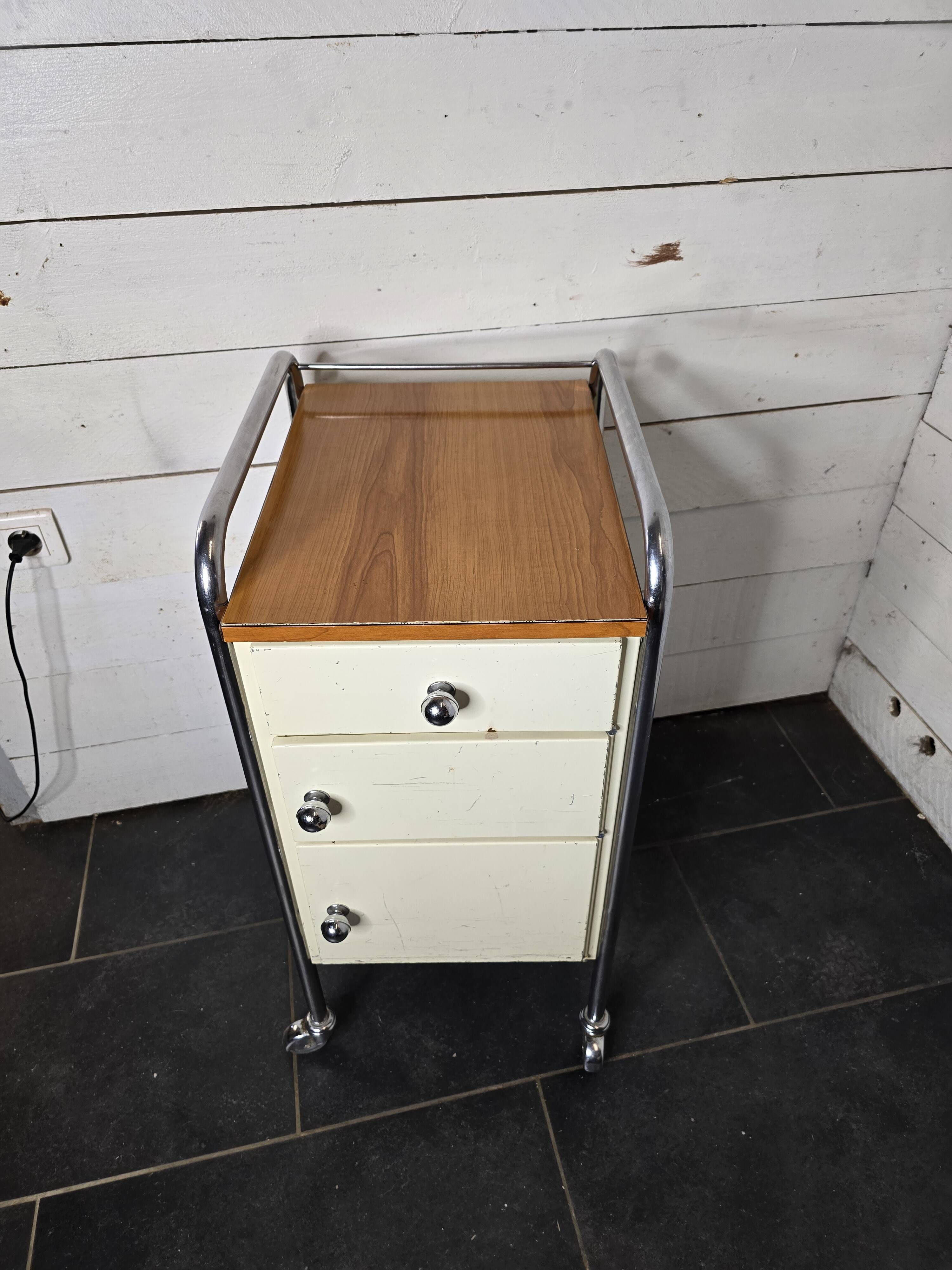 Mid-20th century metal cabinet table on wheels
