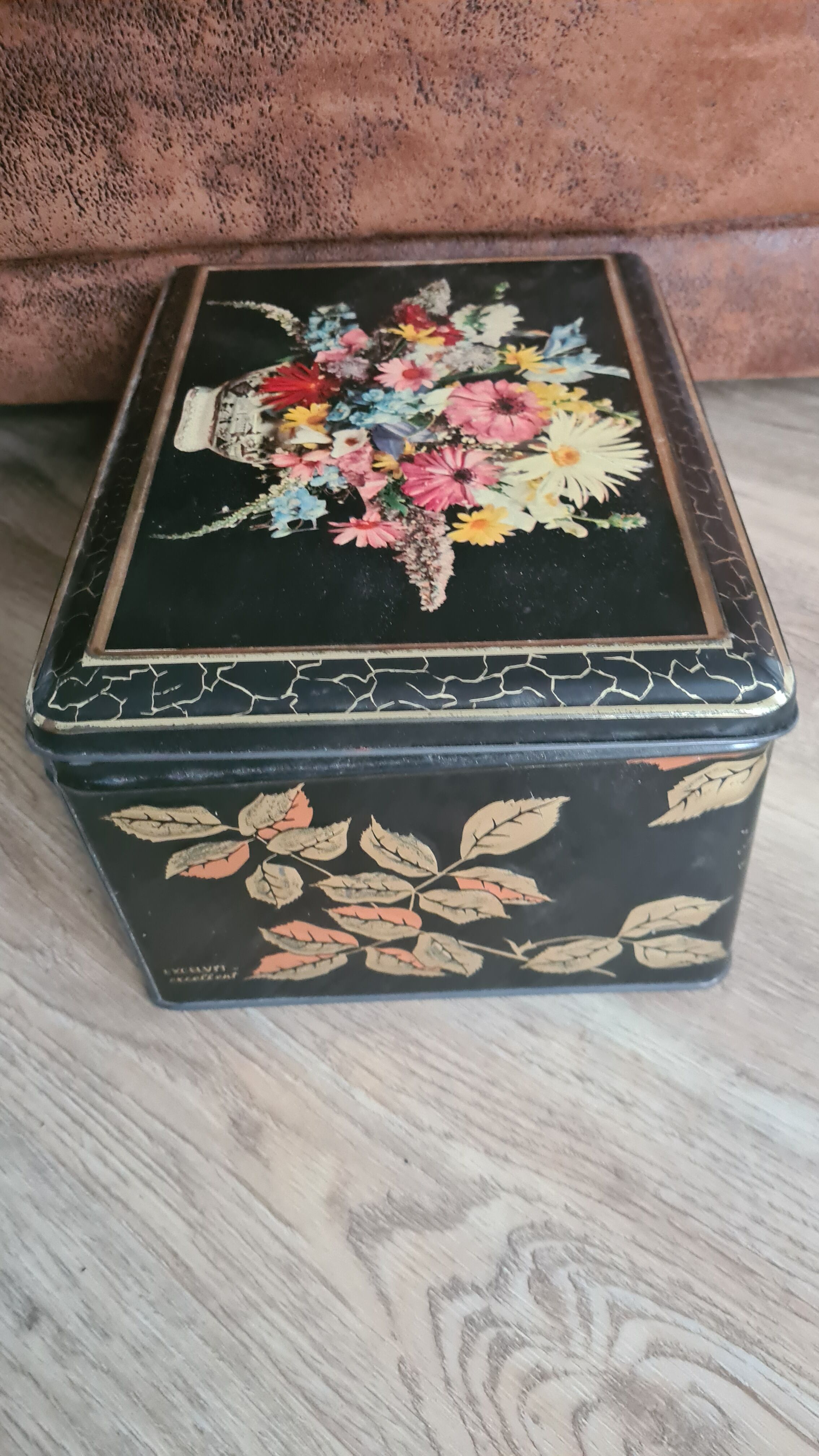 Old black metal box and flowers at the beginning of the century