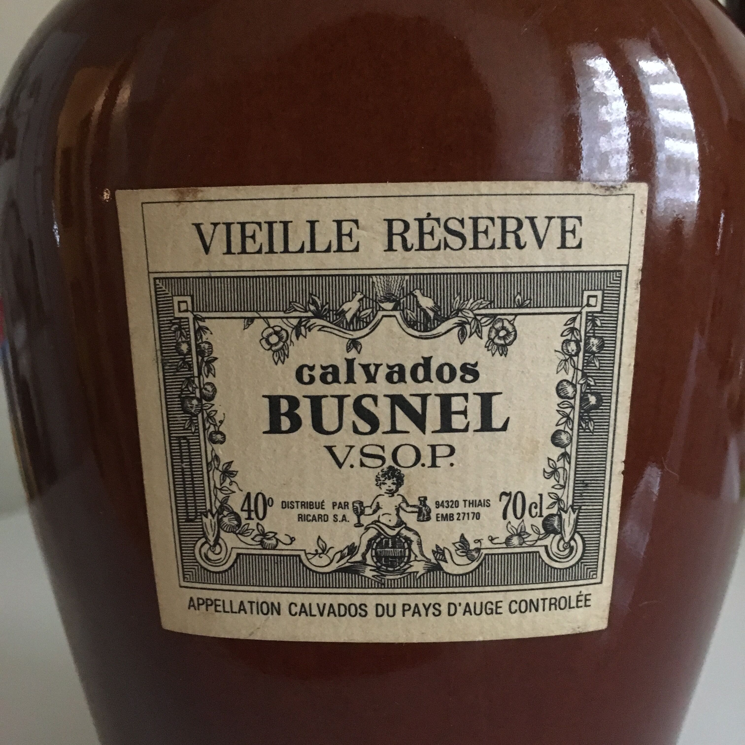 Old bottle of Calvados in sandstone