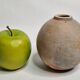 Round ceramic vase with raw finish, smoked firing, signed, late 20th century, 11 cm.
