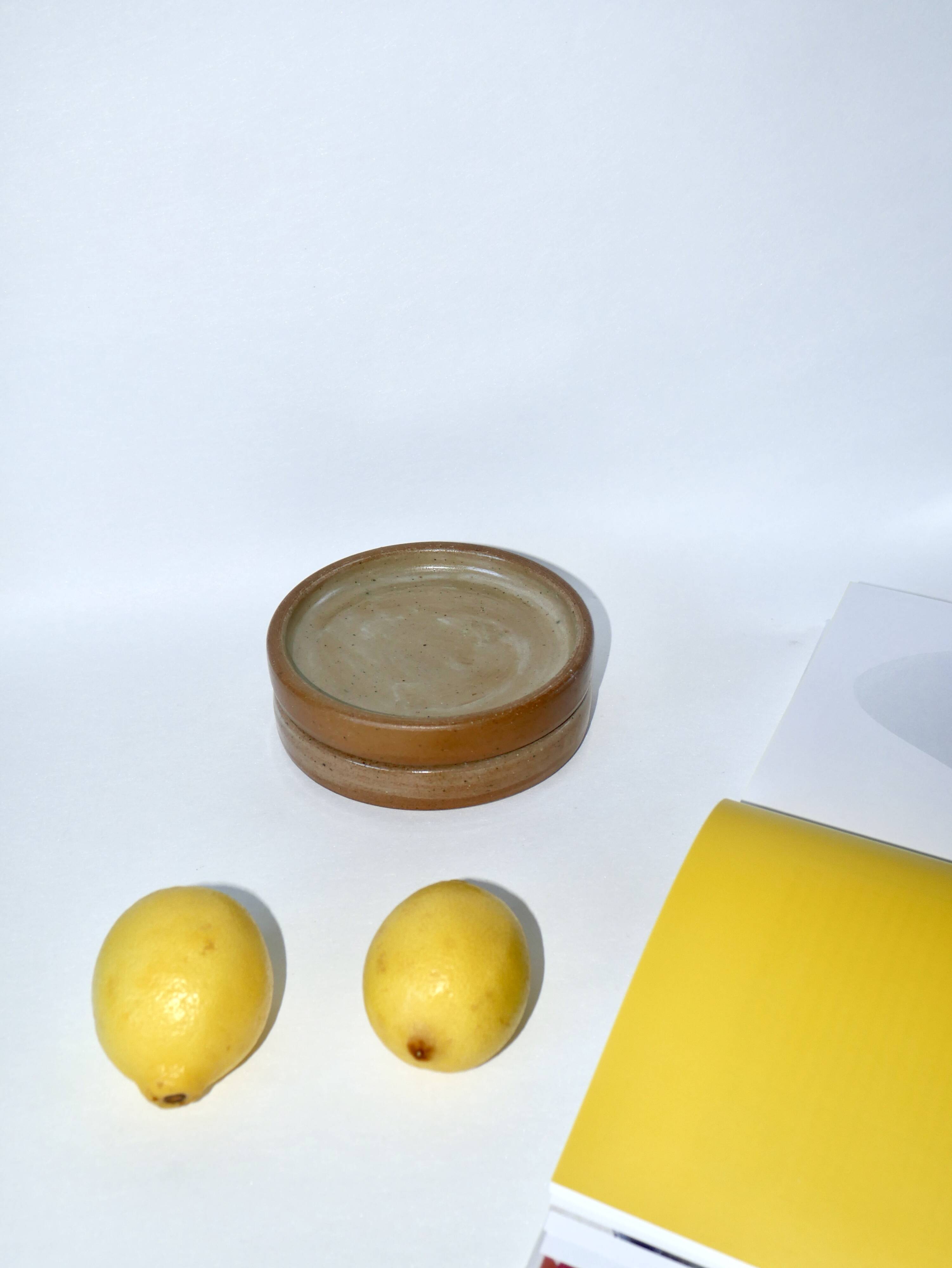 Pair of enamelled stoneware bottle coasters 1970