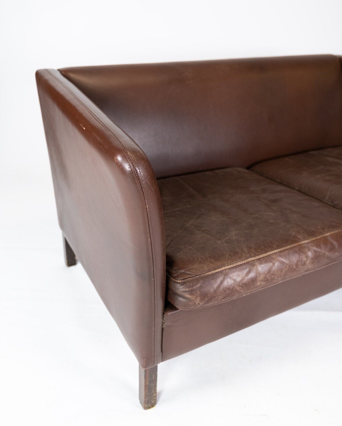 Two seater sofa upholstered with dark brown leather of danish design , by Stouby Furniture