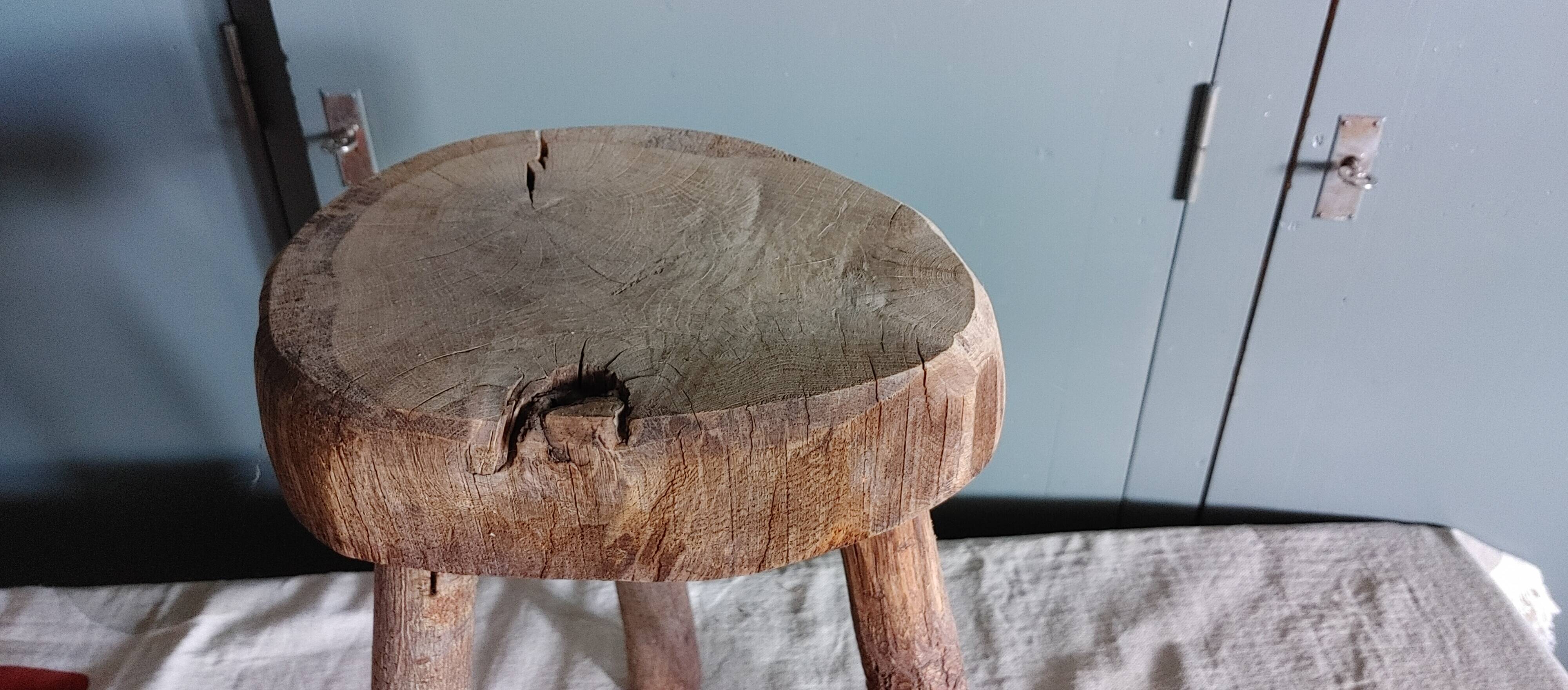 Old small country stool in raw wood - tripod base